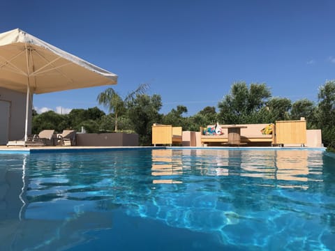 An infinity pool, sun loungers