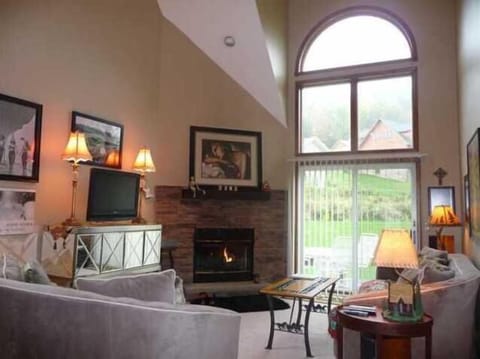 Beautiful 2 story great room with stone fireplace and gorgeous views of chalets 
