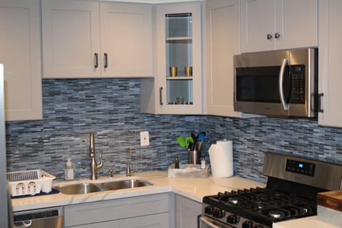 Completely brand new cabinets, back splash, microwave, countertops and stove