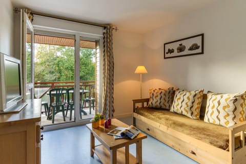 Find peace and relaxation with your close friends and family in this stunning open-concept living room featuring natural decor.