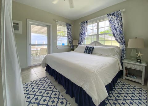 Ocean front bedroom with views of ocean and access to the veranda and beach.
