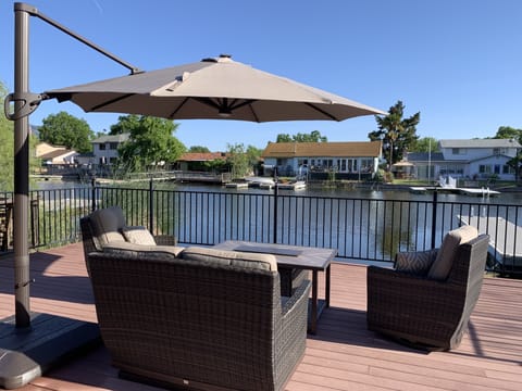 Outdoor sofa and fire pit to enjoy by the water. Watch kids at all times.