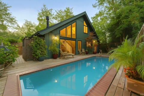 Modern retreat with floor-to-ceiling windows and a private pool. Enjoy a spacious deck, cozy interiors, and lush greenery—perfect for a peaceful escape.