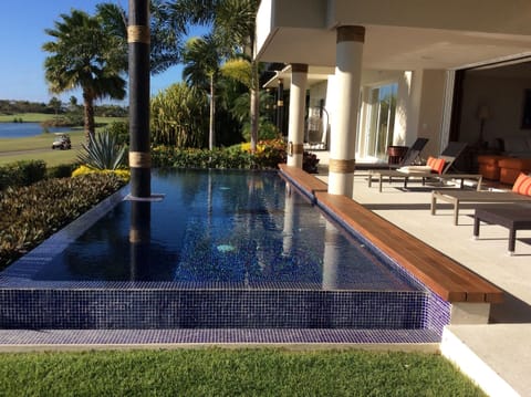 A heated pool, sun loungers