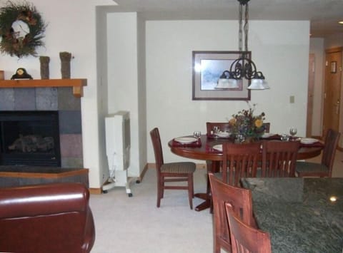 Large open kitchen, dining room, living room, deck, and gas fireplace.