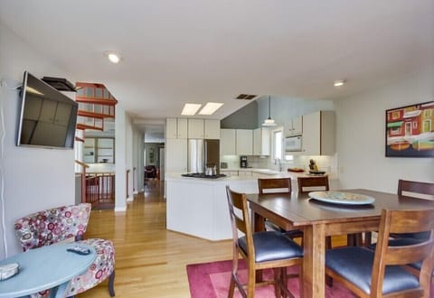 Dining, seating, kitchen area, view from main deck doorway. Flat screen TV.