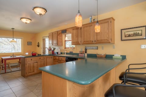 Breakfast bar in kitchen, which has everything you'll need to prepare meals 