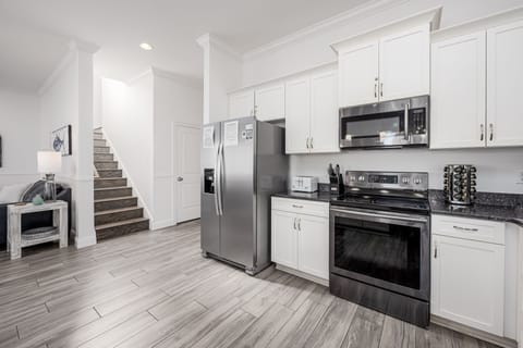 Spacious kitchen. Stairs lead to 2nd floor.