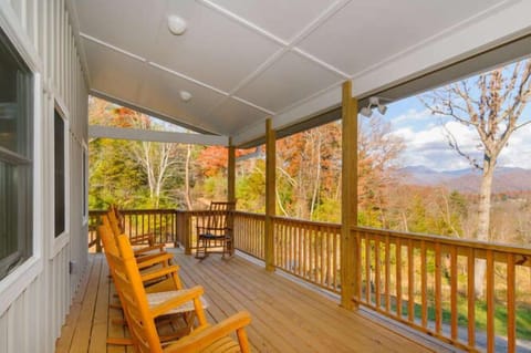 Rocking chairs on a huge covered porch with view and dining