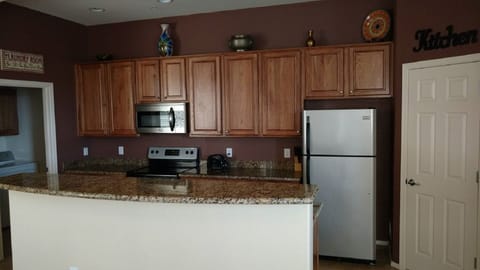 Kitchen with granite counter tops, oak cabinets and stainless steel appliances