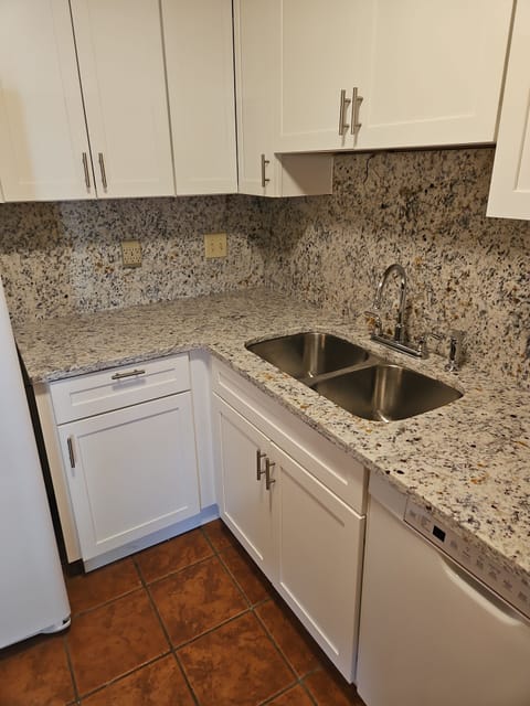 New kitchen with granite countertops and backsplash