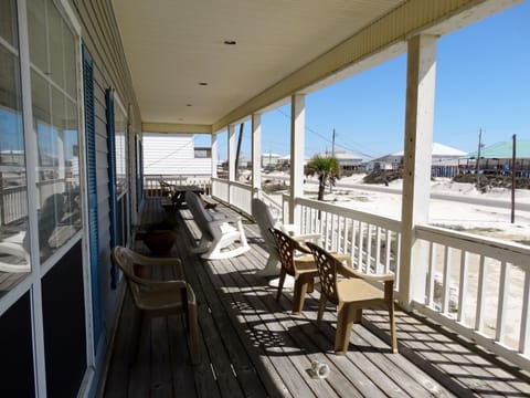 The front porch offers a cool place to relax and look for dolphin swimming by.