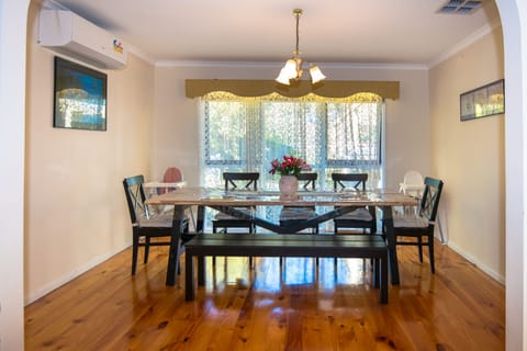Formal Dining, Air conditioned and over looking leafy back yard with wide window