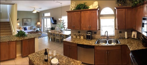 Modern Gourmet Kitchen Open & Inclusive with Main Room- Features Bartop Seating