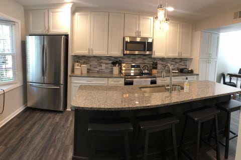 New renovated kitchen with granite countertops, new appliances & tile backsplash