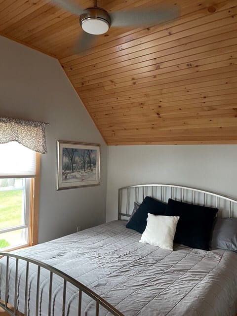 King bedroom upstairs with ceiling fan