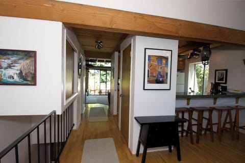Front entrance view into main living area, kitchen and dining area to right
