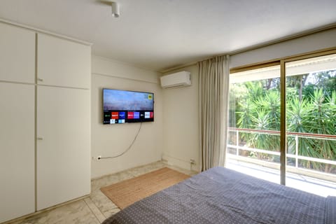 bedroom 2 with 56"smart TV and garden view with private balcony