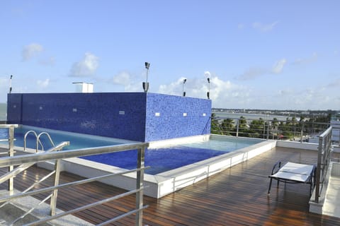 An infinity pool, a rooftop pool, sun loungers