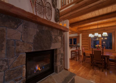 Gas fireplace in living room adjacent to dining area