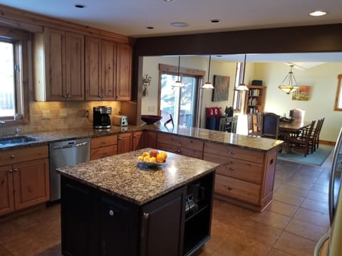 Kitchen view of the dining room and sliding glass door to the fenced backyard.