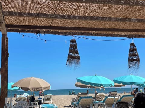 On the beach, sun loungers, beach towels