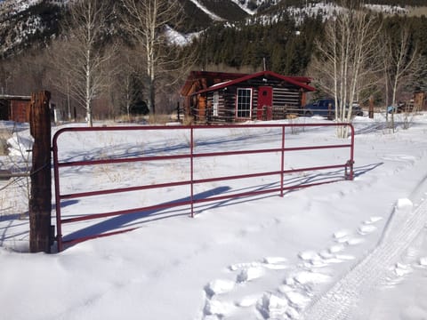 In the Winter, the snow plan comes just past the red gate to our property.