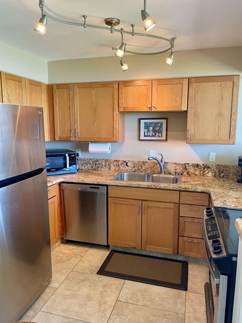 The kitchen boasts granite countertops and stainless steel appliances.