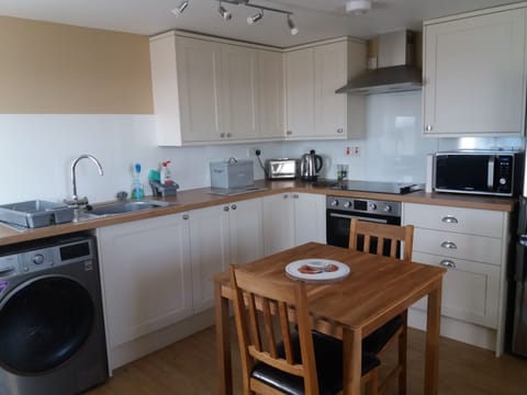 Kitchen area fully equipped with larder fridge freezer, cooker, and microwave.