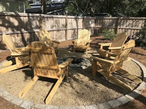 Enjoy the in-ground fire pit and six surrounding Adirondack chairs.