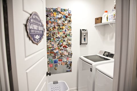 Laundry room with full-size machines; iron & ironing board & other essentials.