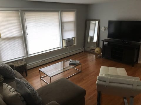 Hardwood floors modern and contemporary furniture featuring a 50 plus inch TV