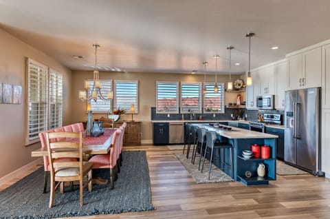 Dining Table & Kitchen Side View - With an open and spacious floor plan, the Dining Room and Kitchen can accommodate meal preparations for groups large or small.