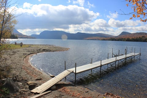 private dock with and sandy, shallow water access on south edge of property.