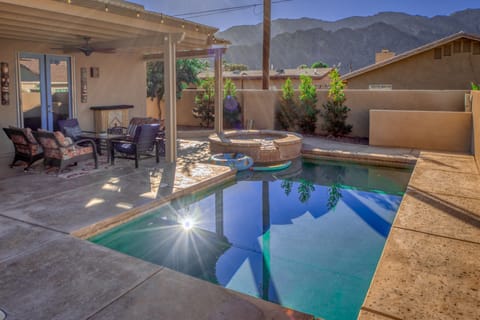Heated saltwater pool and spa with mountain view and misting system.