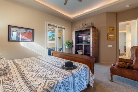 Master bedroom with smart TV and french doors that leads to the pool and patio!