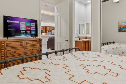 Cactus room with King bed, Smart TV, door to great room and bathroom vanity.