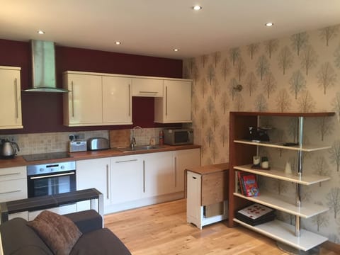 Modern fitted kitchen including dishwasher, fridge freezer, cooker and microwave