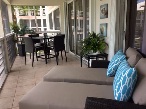 The screened balcony overlooks the grounds of beautiful Ocean Club West.