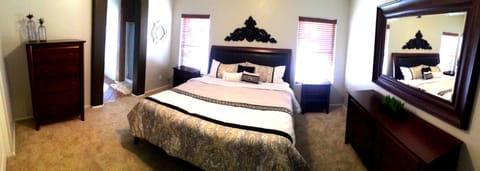 Master Bedroom with California King Bed, Dressers and TV