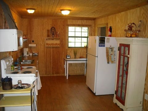 Kitchen, fully stocked with dishes, pots and pans and utensils, coffee maker.