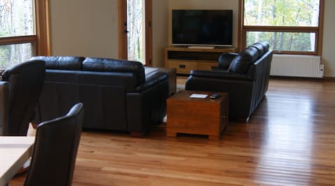 Leather sofas in spacious living room. Free high speed Wi-Fi on property.