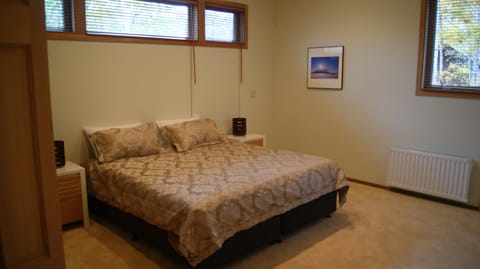 Bedroom with space for extra futon mattresses. King bed setup can be rearranged.