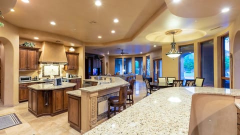 Large, gorgeous kitchen w/ island, counter seating, separate bar, & dining table