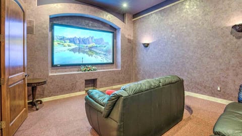 Theater room w/ comfy couches, sound system, projector TV, & popcorn machine