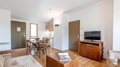 Relax on the comfortable sofa and watch a show on the TV.