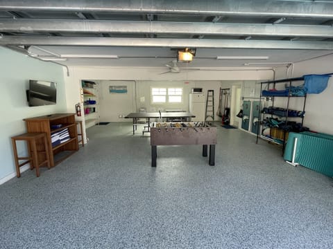 Recreational garage off the pool holds games and amenities for all ages.
