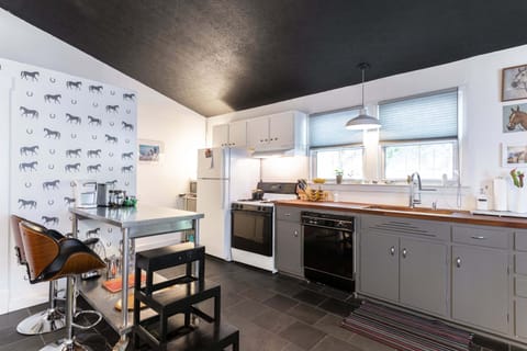 Gas stove, dishwasher, farmhouse sink, repurposed vintage cabinets. Well stocked