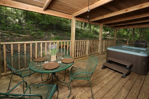 Outdoor eating area is adjacent to hot tub.