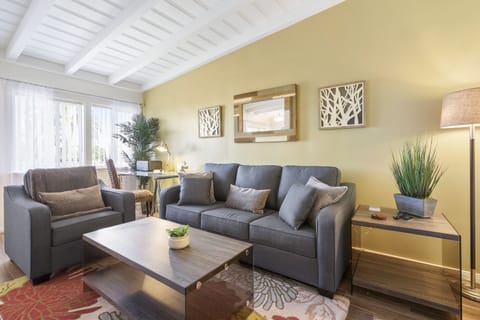 The living room with natural light and accented by original artwork.